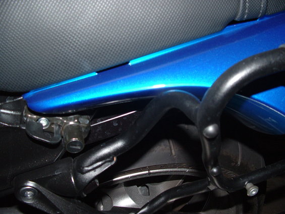 Blue motorcycle frame with black crash bars and seat detail