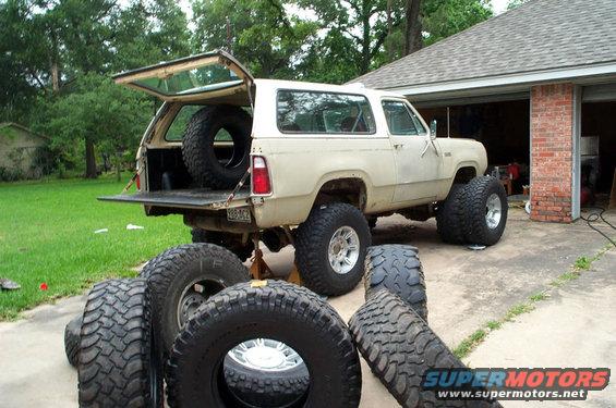 Tan 1978 Dodge Power Ram with large tires and spare in the back