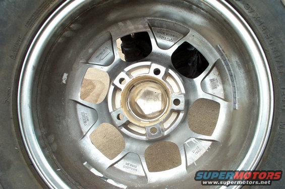 Close-up of a vehicle's alloy wheel with tire. Shows balance weights and 'Made in China' text on the wheel