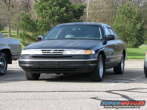 Black sedan, front view. Appears to be a 1995 Ford Crown Victoria