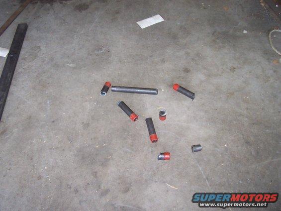 Several metal tubes, some with red caps, scattered on a concrete floor