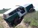 1980 Ford F-250 - Off-roading vehicle is stuck in a ditch with its tires digging into the dirt.