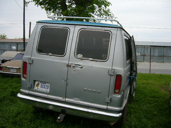Silver 1978 Ford E250 van with a blue roof, rear doors, and a Texas license plate