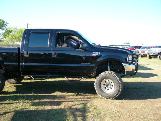 Black lifted Ford F-250 Super Duty pickup truck, side view