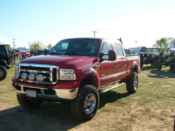 Red Ford F-250 Super Duty pickup truck with chrome accents and aftermarket lights