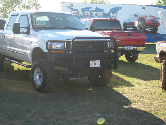 White Ford F-250 Super Duty pickup truck with brush guard and Texas plates