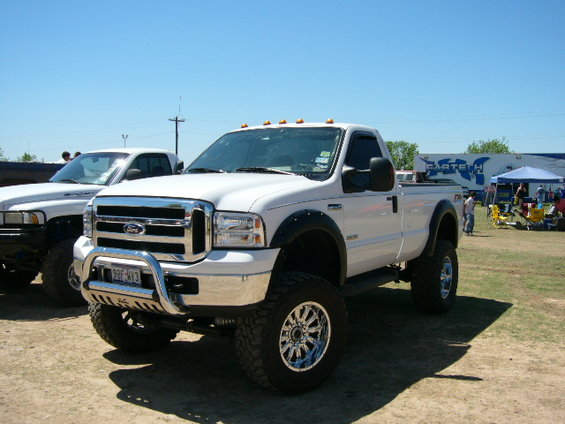 White Ford F-250 Super Duty pickup truck with chrome grille and bull bar