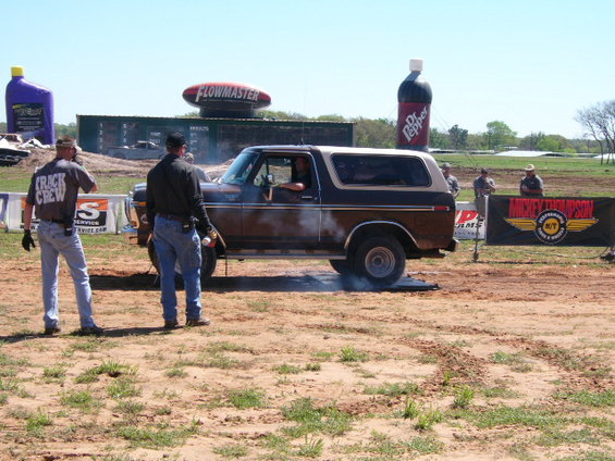 Brown and tan 1978 Ford Bronco doing a burnout