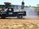 1978 Ford Bronco - A blue 1956 Ford F-100 pickup truck is doing a burnout at an outdoor event.