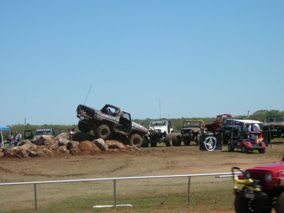 1978 Ford Bronco climbing rocks, camouflage paint, lifted suspension, off-road tires