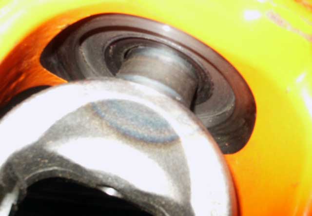 Close-up of yellow and orange part with black rubber seal