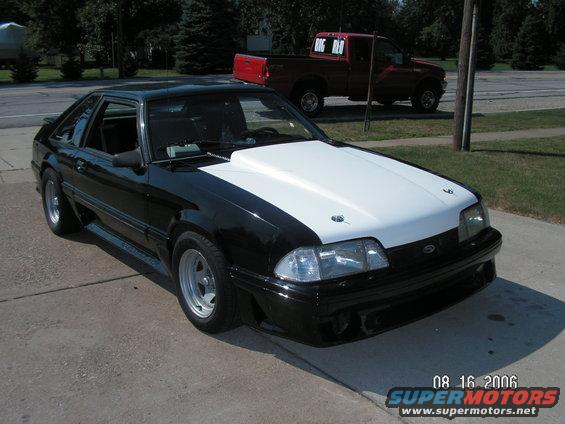 Black and white 1988 Ford Mustang with a white cowl induction hood