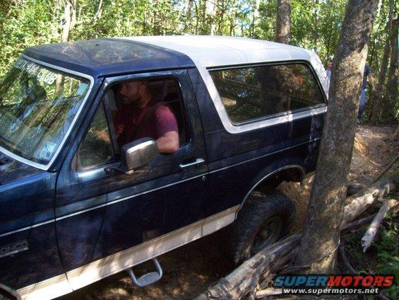 1992 Ford Bronco off-roading, dark blue with white top