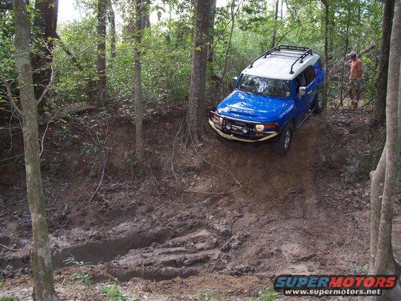 Blue Toyota FJ Cruiser on a muddy trail