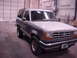 1990 Ford Bronco II - This two-door Ford Bronco II, seen from a three-quarter front angle, is parked inside a garage.