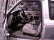 1990 Ford Bronco II - The interior of a Ford Ranger is shown with the driver's side door open and parts removed.