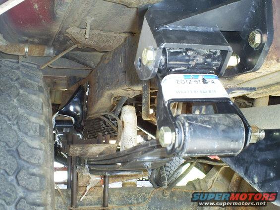 Close-up of a leaf spring suspension component with a part number label