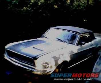 1968 Ford Mustang convertible, white with black stripes on hood, black soft top, parked outdoors