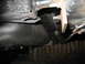 1985 Ford Crown Victoria LTD - Close-up view of the underside of a vehicle, showing the fuel tank and frame structure.