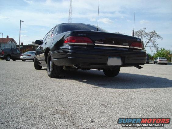 Black 1992 Ford Crown Victoria sedan, rear view, with aftermarket wheels and a clean body