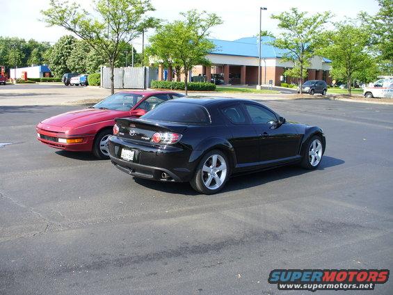 Black Mazda RX-8 and red Mazda MX-6 parked in a lot