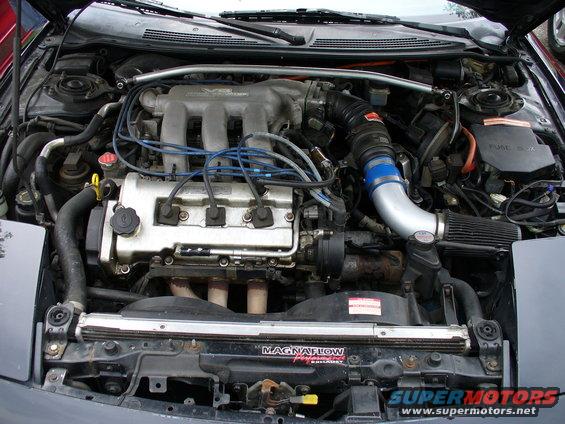 1991 Ford Probe engine bay with V6 intake manifold, blue spark plug wires, and aftermarket air intake