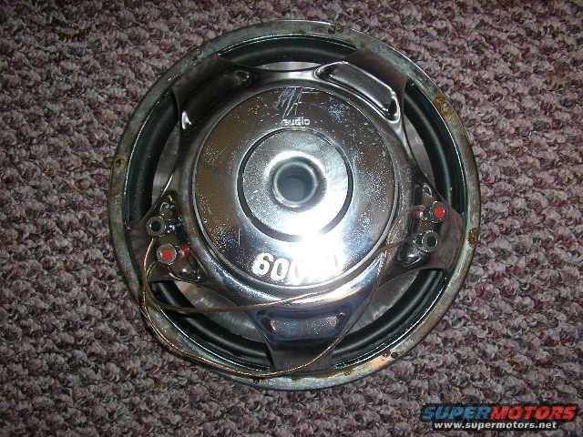 Car speaker with 'AUDIO' and '600' visible on the back. It's sitting on carpet