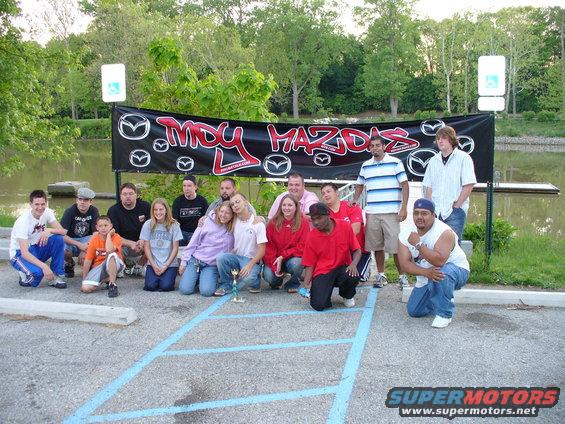 Group of people in front of a "MDY MAZDAS" banner
