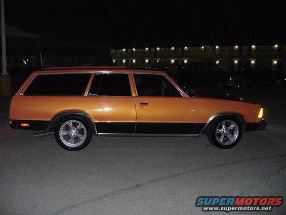Orange and black station wagon, side view