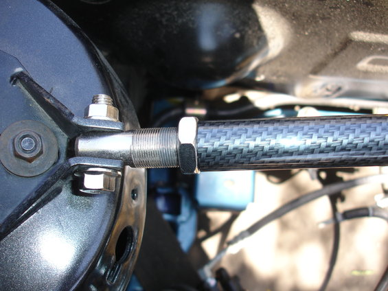 Carbon fiber strut tower brace attached to black component