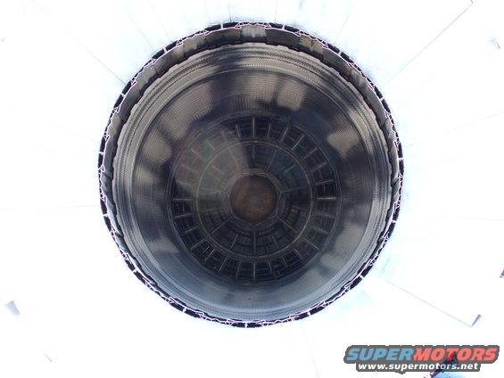 Looking into a large, circular exhaust pipe opening with internal baffles