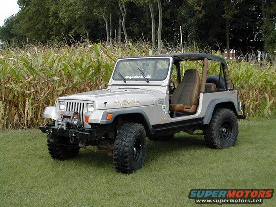 Silver Jeep Wrangler with "Big Daddy" decal on fender and "Jeep Jamboree USA" sticker on windshield