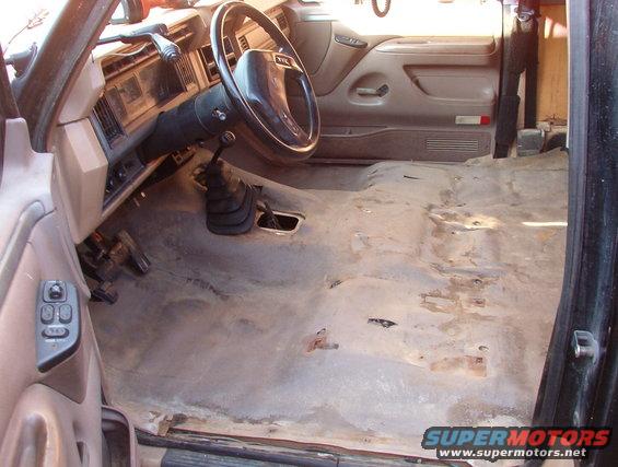 floorempty.jpg I'm planning on swapping transmissions soon anyway, so I pulled the seats & console to check out the floor.