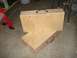 1999 Ford Crown Victoria - Two wooden toolboxes with metal handles are stacked on a concrete floor.