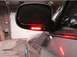 1999 Ford Crown Victoria - Close-up of a side mirror with a row of red LED turn signal lights illuminated.