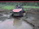 1984 Ford Bronco - This off-road buggy is deeply stuck in a muddy terrain, with its front tires barely visible.