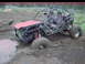 1984 Ford Bronco - This custom off-road vehicle is deeply embedded in thick mud, with its front tire submerged.