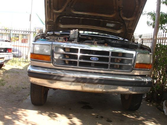 Front view of a 1992 Ford F-350 with hood open, showing grille and headlights