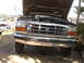 1992 Ford F-350 - The front of a 1992 Ford F-350 truck is shown with its hood open, revealing the engine compartment.