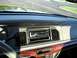2000 Mercury Grand Marquis - Interior view of a 2000 Mercury Grand Marquis dashboard with aftermarket stereo and wood grain trim.