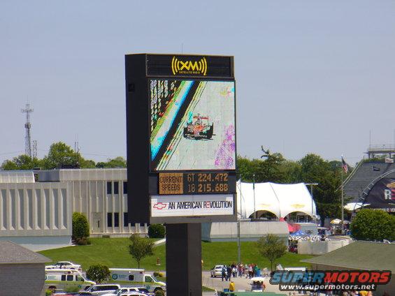 Screen displaying a racing car and race data, with Chevrolet logo