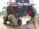1989 Ford Bronco - This heavily modified off-road vehicle is attempting to traverse a large tree stump on a dirt course.