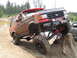 1989 Ford Bronco - A heavily modified red SUV navigates an obstacle course, covered in mud.