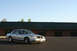 2004 Ford Crown Victoria - A silver 2004 Ford Crown Victoria is parked outside a commercial building under a clear blue sky.