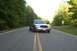 2004 Ford Crown Victoria - Silver 2004 Ford Crown Victoria on a paved road with trees lining the sides.