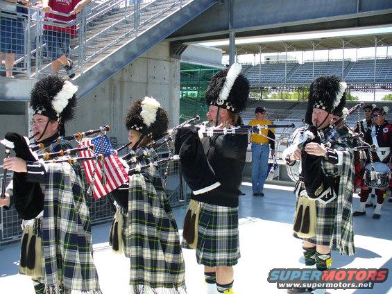 Bagpipers in kilts with American flags