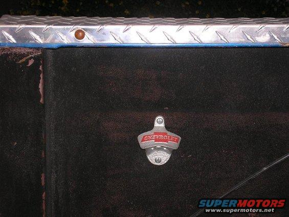 Chevrolet bottle opener mounted on a dark, textured surface with a diamond plate trim above
