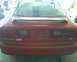 1993 Ford Probe - The rear of a red 1993 Ford Probe GT is visible, showing the spoiler and GT badging.