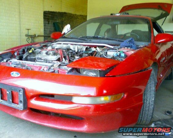 Red 1993 Ford Probe with hood and trunk open, front view
