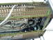 2007 Ford Mustang - The underside of a vehicle is visible, secured to a transport trailer with chains and straps.